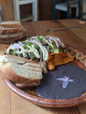 Vegan chilaquiles with potato "queso" at Yum Yum San Pancho in San Francisco