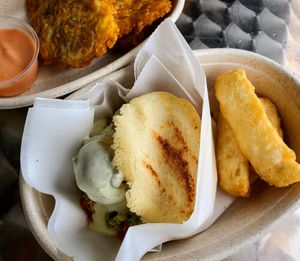 BBQ Arepa, yuca fries, and garlic tostanes up top. at Earth To Us in Raleigh