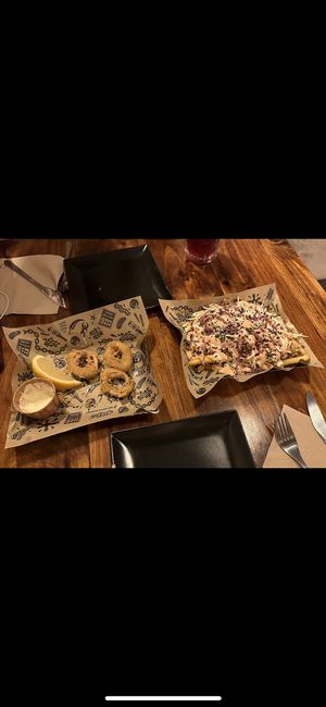 half eaten calamari🤓 and supreme yoyo fries  at Mad Mad Vegan - Lavapiés in Madrid