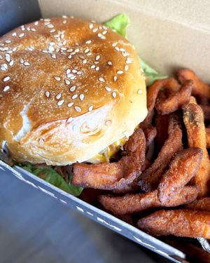 Delivered Mad Signature Burger with sweet potato fries at Mad Mad Vegan - Lavapiés in Madrid