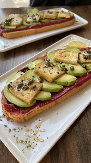 Toast with beetroot hummus, avocado, tofu   at TOST. in Malaga