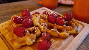 Waffles with maple syrup and raspberries at Love Peace & Coffee in Edinburgh