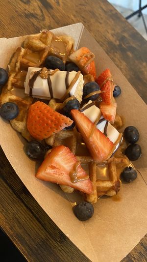 Waffles with vegan Kinder Bueno, strawberries and blueberriess  at Love Peace & Coffee in Edinburgh