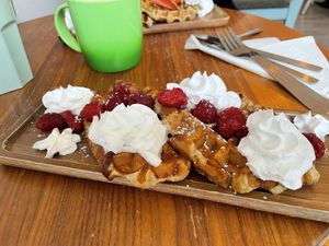 Waffles and raspberries with whipped cream   at Love Peace & Coffee in Edinburgh