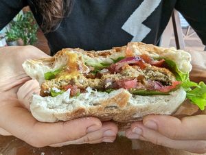 There is lettuce, tomato, and onion on either side of the patty. Love it! at Rinconcito Vegano in Boquete