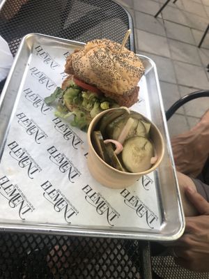 Fried chicken sandwich with side of spicy cucumber salad at Element Gastropub in Raleigh