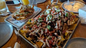 Loaded fries and loaded nachos with sour cream at Element Gastropub in Raleigh