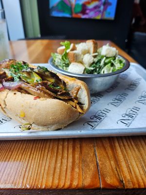 Philly cheesesteak with kale salad side at Element Gastropub in Raleigh