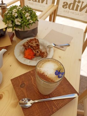 Olive latte and vegan carrot cake. at Nibs Healthy Bar in Menorca