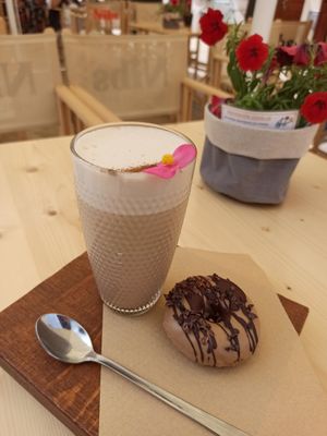 Chai latte + vegan donut 🍩 at Nibs Healthy Bar in Menorca