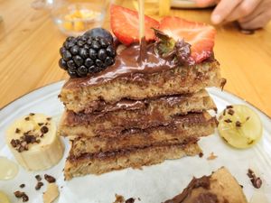 Vegan pancakes with chocolate spread and fresh fruit at Nibs Healthy Bar in Menorca