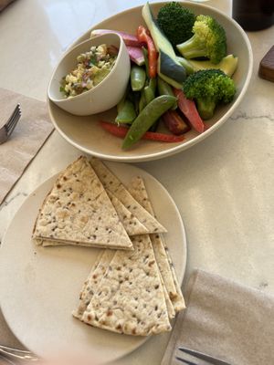 Side of pizzas with avocado hummus platter  at Flower Child in Denver