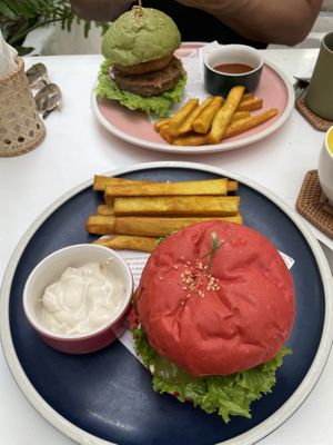 Green: beyond meat burger, red: meat burger (but with bean patty)  at iVegan Supershop Da Nang - Healthy Plant Based Cafe in Da Nang