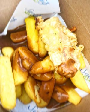 Battered sausage, chips and gravy  at Saving Nemo in Darlington