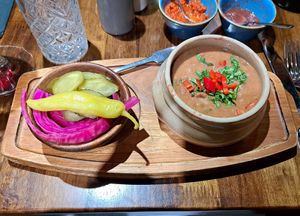 Lobio (bean stew), pickles, and adjika & tkhemali sauces in the background at Kartuli in South East London