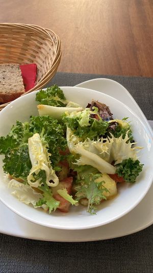 First: potato and tomato salad, greens. Free bread   at Ca n'Ela Vegan Restaurant in Mallorca
