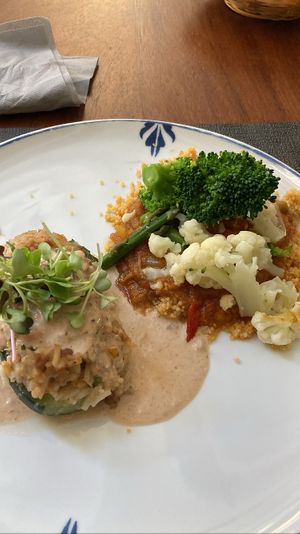 Main: stuffed zucchini with rice and satay sauce. Couscous with tasty sauce and veggies. Usually you choose one main. Staff sometimes offers you both if you can’t decide   at Ca n'Ela Vegan Restaurant in Mallorca