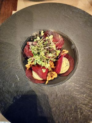 Raw beetroot ravioli, cashew cheese with yellow pepper sauce and walnuts.  at Ca n'Ela Vegan Restaurant in Mallorca