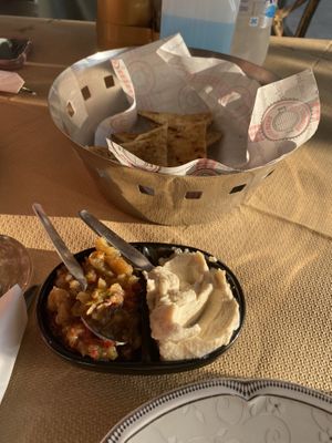 Complimentary lemon hummus and eggplant dip with pita  at Pheidias Grill House in Olympia