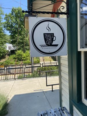 The trails end cafe sign with the railroad in the background   at Trail's End Cafe in Bala Cynwyd