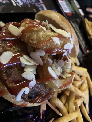 Dodge with veggy burger onion rings and almonds   at Unic Bar in Vanzago