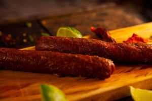 The house sausage on the grill harmonizes perfectly with a craft beer at A Coruja in Sao Paulo
