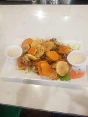 Fried potatoes, yams, and cauliflower sitting on top of salad with tahini sauce! at Allan's Mediterranean Bar and Grill in Middletown