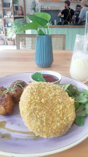 Baked potatoes, vegan patty, greens and beetroot dressing at Chutnej in Prague