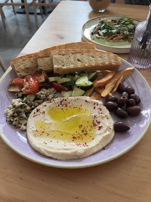 Antipasti - bread, hummus, vegan cheese, olives, pickled carrots ,cucumbers, and tomatoes.  at Chutnej in Prague