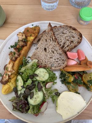 Omelet with shiitake mushroom and side of fermented veggies  at Chutnej in Prague