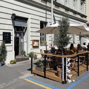 Façade with outdoor seating  at Chutnej in Prague