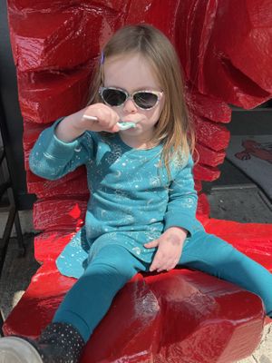 Toddler enjoying vegan arctic mint ice cream   at Ben & Bill's Chocolate Emporium in Bar Harbor