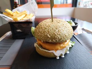 Burger with vegan cheddar, fries and a side salad at Reed in Luxembourg City