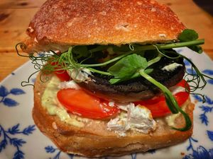 balsamic glazed portobello mushroom with tomato and greek style vegan cheese with sweet basil mayo on a sourdough ciabatta roll at Elodie's  in Kirkby Lonsdale