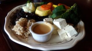 The Rosendale Cafe's "Zen Platter," one of the restaurant's vegan offerings, from a visit in May 2017. This entree was ordered with the steamed vegetables cooked al dente. The reviewer chose the tahini sauce, seen in the foreground. In addition to the veggies and sauce, the dish also includes tofu, black beans, and brown rice.  at The Rosendale Cafe in Rosendale