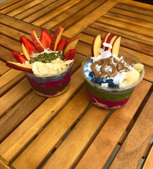 A smoothie bowl with a base of acai, pitaya, and blue majik and another smoothie bowl with a base of pitaya, power greens, and blue chia pudding. at Terra Superfoods in Monterey
