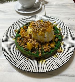 Vegan pandan coconut waffles, with granola topping, mango cubes, coconut ice-cream and gula melaka syrup   at Oatberry Cafe - Scotts Square in Central Singapore