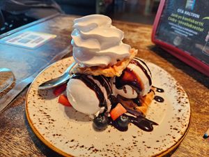Croffle: vanilla oat ice cream between croissant waffles, berries, choco sauce & whipped cream (8.5€) at Junk y Vegan in Helsinki