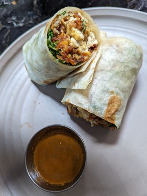 Vegan sausage burrito, comes with tofu and greens, and hot sauce on the side. at Copa Vida in San Diego