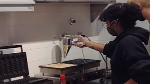 Making the mini pancakes at Coconut Whisk in Minneapolis