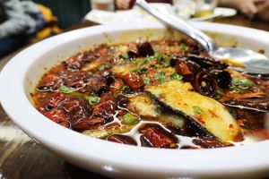 Sliced fish in sizzling oil  at Tofu Vegan - Islington in North London