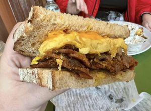 Pastrami Brekkie Sandwich (pastrami, caramelized onions, egg, cheddar, and horseradish mustard on my choice of red hot chili pepper bread)  at Take Two Cafe in Schenectady