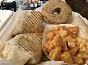 Buffalo mac wrap with chipotle potato salad and a Strawberry Snail chai caramel doughnut  at Take Two Cafe in Schenectady