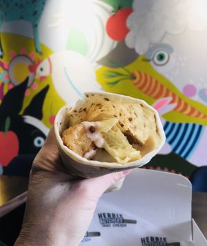 Cheesy egg chicken wrap. Bomb as hell 🔥  at Herbie Butcher's Fried Chicken in Minneapolis