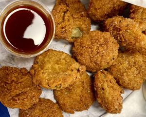 Deep Fried Pickles! They are salty, crispy, and awesome with both sweet heat sauce (pictured) and ranch 💚  at Herbie Butcher's Fried Chicken in Minneapolis