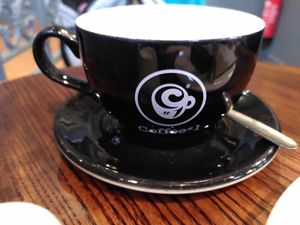 Teacup with logo (November 2024) at Coffee #1 in Aberystwyth