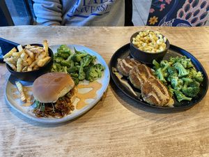 Nguru (pulled bbq sandwich made with oyster mushrooms), side of broccoli and fries; & Dagaa (“crab” cakes, side of Mac and cheese and broccoli)   at Michezo Vegan Cafe in South Orange