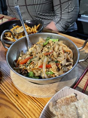 Vegan noodles with the chili crisp garlic French fries in the background   at M Pocha in Durham