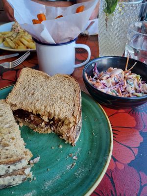 Sausage sarnie with slaw and sweet potato fries- delicious 😄 at Lounges - Tretho Lounge in St Ives