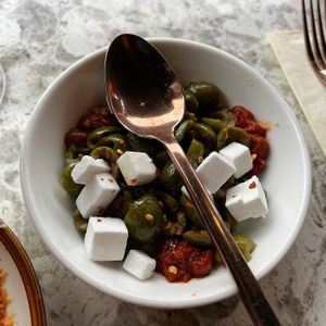 Olives with ndjuna, coconut feta and orange  at Soda Club in New York City